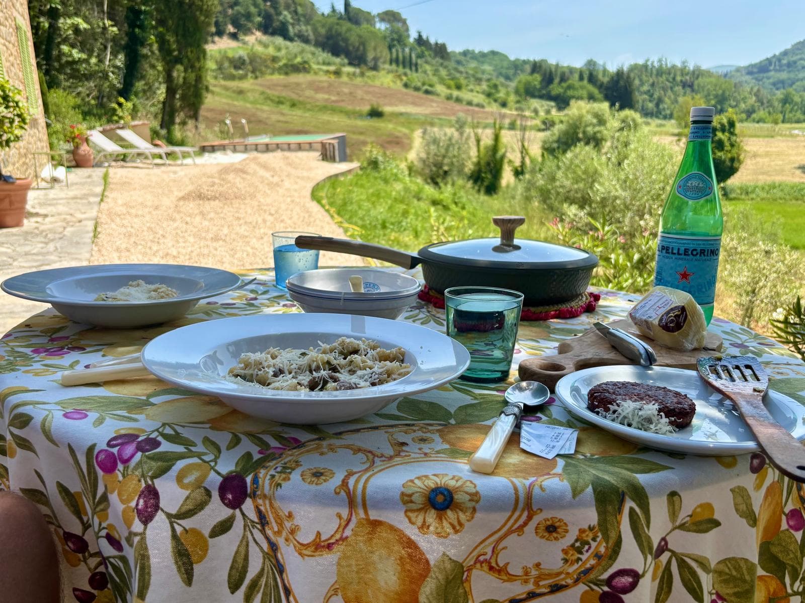 Outdoor lunch spread on the terrace with countryside hills